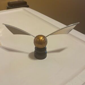 Golden snitch replica model with wooden stand